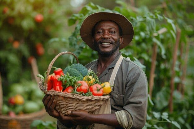 Smiling African farmer holding a basket of fresh produce